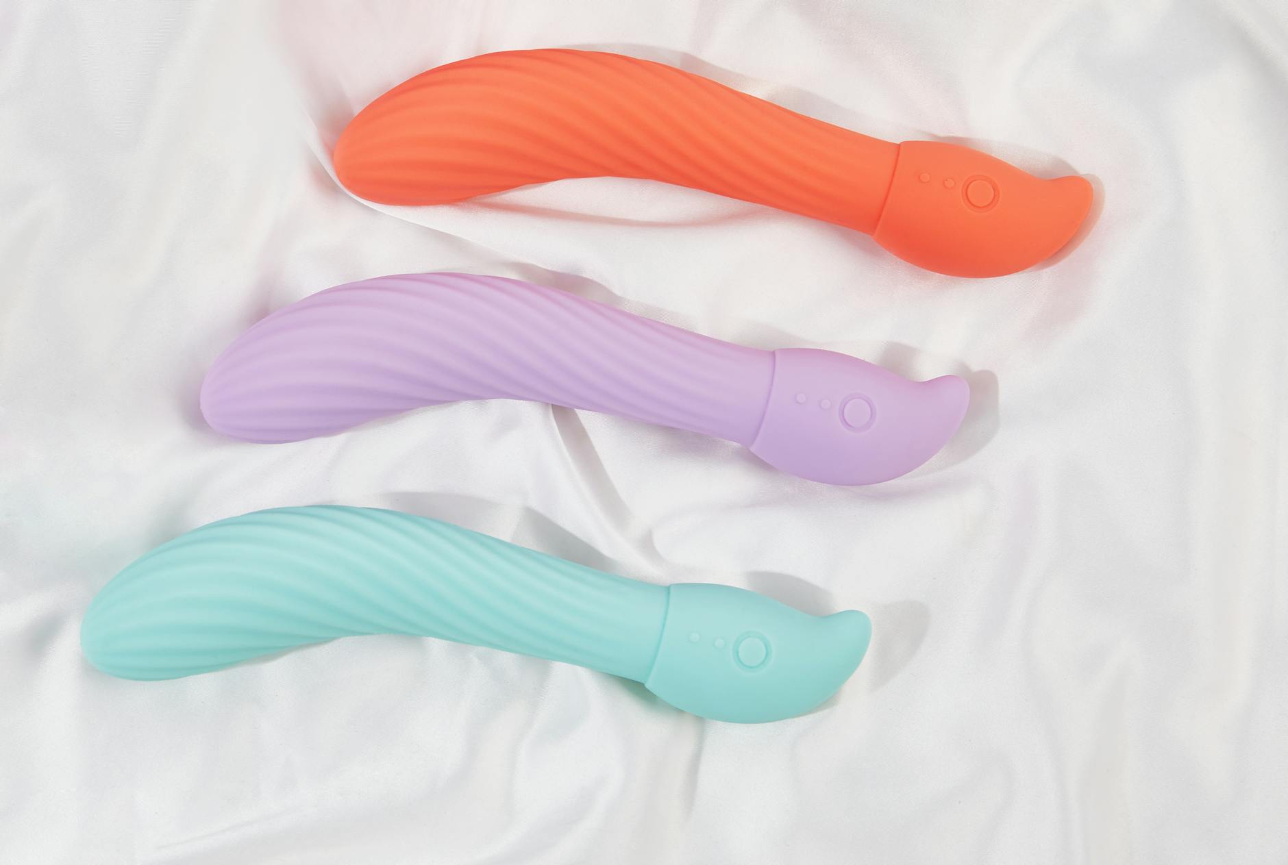 A blue silicone clitoral vibrator held in hand, symbolizing reclaiming pleasure and self-care during stressful periods.