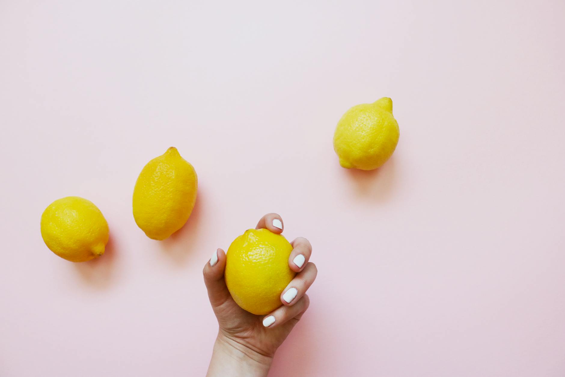 Two hands holding fresh lemons, symbolizing openness and natural pleasure