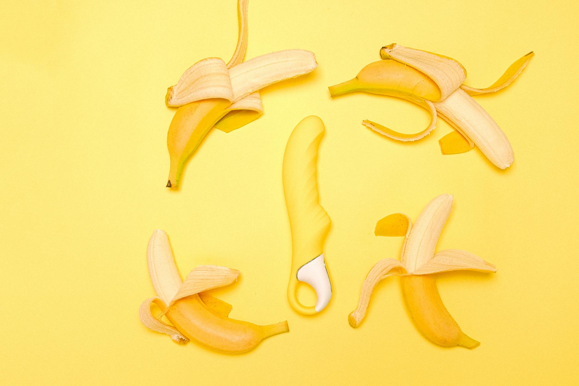 Close-up of hands holding colorful adult toys, representing openness and communication about intimacy