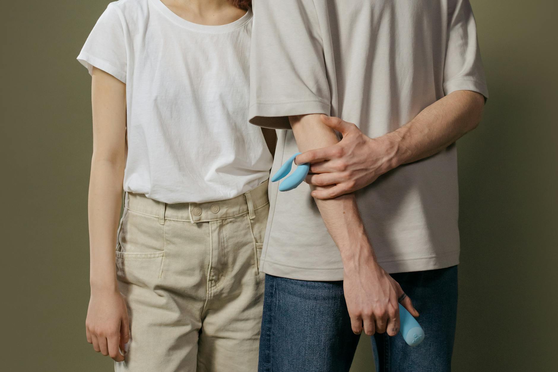A young couple standing together indoors, discussing intimacy and trust
