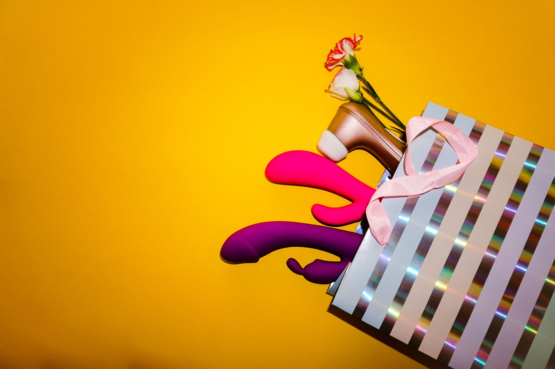 A hand holding a lemon against a vivid yellow background, symbolizing freshness and vitality
